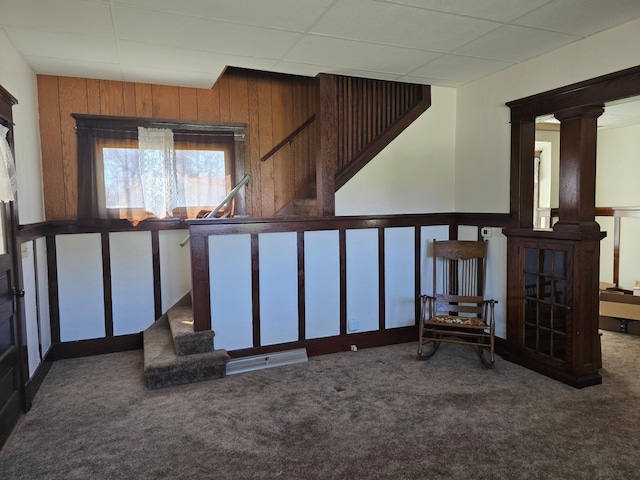 interior space featuring a paneled ceiling and carpet