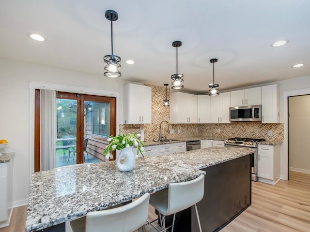 2415 Edgerton St, Little Canada, MN 55117 - kitchen featuring appliances with stainless steel finishes, a sink, white cabinetry, tasteful backsplash, and recessed lighting