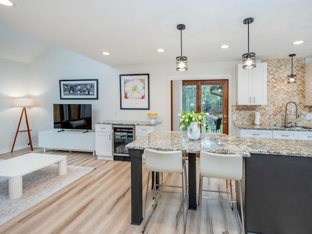 2415 Edgerton St, Little Canada, MN 55117 - kitchen featuring wine cooler, a sink, light wood-style floors, white cabinetry, and recessed lighting