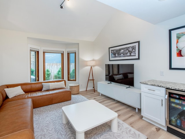2415 Edgerton St, Little Canada, MN 55117 - living room with beverage cooler, light wood finished floors, vaulted ceiling, and rail lighting