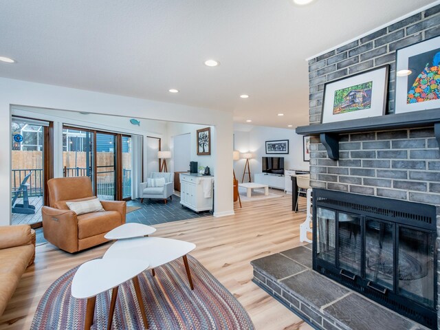 2415 Edgerton St, Little Canada, MN 55117 - living room with a brick fireplace, wood finished floors, recessed lighting, and baseboards