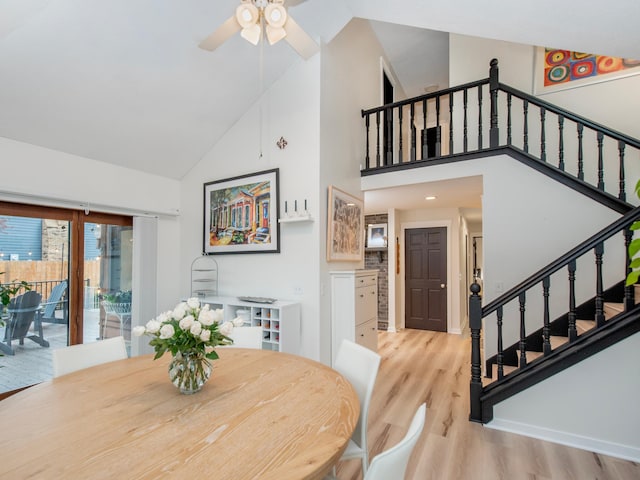 2415 Edgerton St, Little Canada, MN 55117 - dining space featuring high vaulted ceiling, light wood-style flooring, stairs, and a ceiling fan