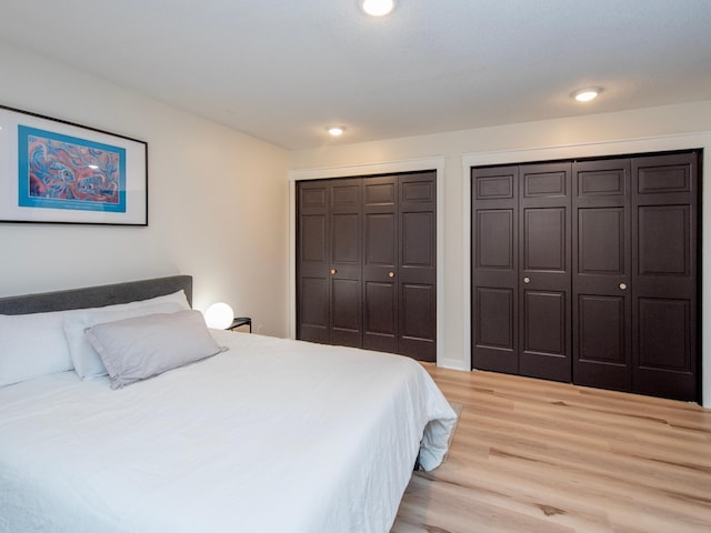 2415 Edgerton St, Little Canada, MN 55117 - bedroom featuring light wood finished floors, two closets, and recessed lighting