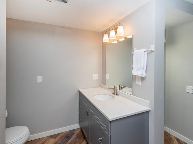2415 Edgerton St, Little Canada, MN 55117 - half bath featuring wood finished floors, vanity, baseboards, and toilet