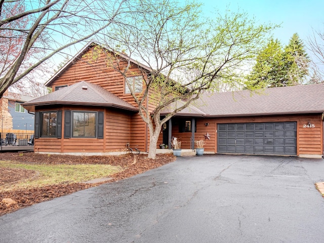 2415 Edgerton St, Little Canada, MN 55117 - chalet / cabin featuring asphalt driveway, an attached garage, and a shingled roof