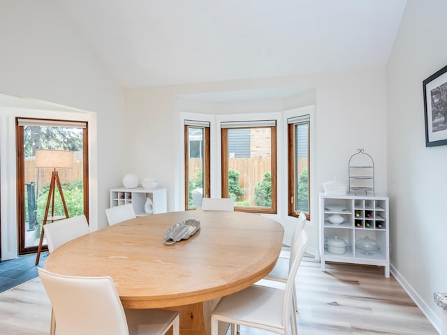 2415 Edgerton St, Little Canada, MN 55117 - dining room with light wood-style floors, lofted ceiling, and baseboards