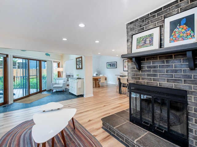 2415 Edgerton St, Little Canada, MN 55117 - living area with a brick fireplace, recessed lighting, wood finished floors, and baseboards