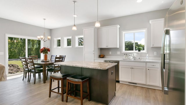 231 Emmy Ln, Hanover, MN 55341 - kitchen featuring appliances with stainless steel finishes, a sink, light wood finished floors, and a center island