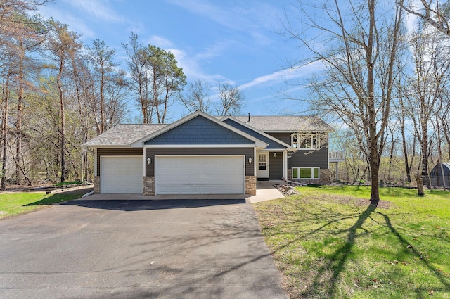 23465 7th St NE, East Bethel, MN 55005 - view of front of home with an attached garage, a front yard, brick siding, and aphalt driveway