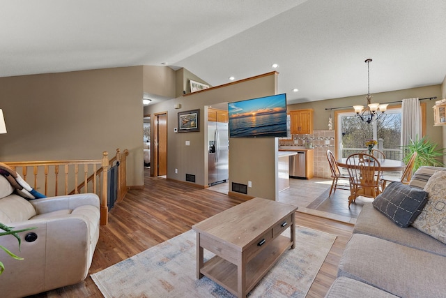 23465 7th St NE, East Bethel, MN 55005 - living room featuring recessed lighting, a chandelier, light wood finished floors, and lofted ceiling