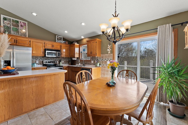 23465 7th St NE, East Bethel, MN 55005 - dining room featuring a notable chandelier, recessed lighting, light tile patterned flooring, and lofted ceiling