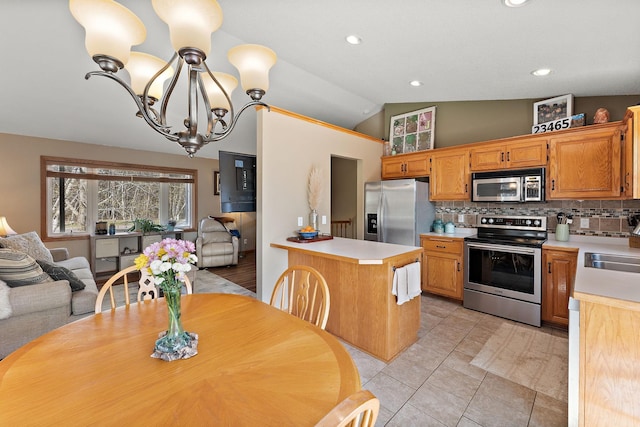 23465 7th St NE, East Bethel, MN 55005 - kitchen with tasteful backsplash, light countertops, lofted ceiling, an inviting chandelier, and stainless steel appliances