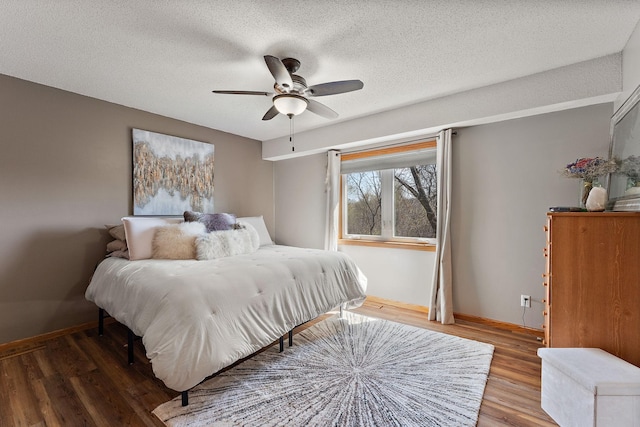 23465 7th St NE, East Bethel, MN 55005 - bedroom with baseboards, a ceiling fan, a textured ceiling, and wood finished floors