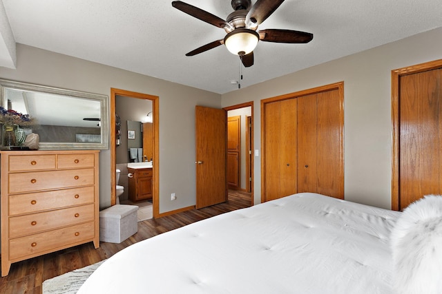 23465 7th St NE, East Bethel, MN 55005 - bedroom featuring a ceiling fan, dark wood finished floors, baseboards, two closets, and ensuite bathroom