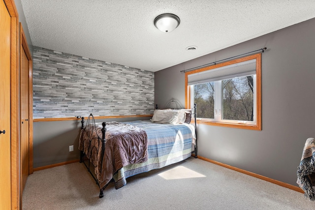 23465 7th St NE, East Bethel, MN 55005 - bedroom with baseboards, carpet, a textured ceiling, and visible vents