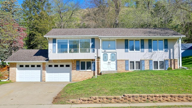 2010 Twin Bluff Rd, Red Wing, MN 55066 - split foyer home with a front lawn, brick siding, concrete driveway, roof with shingles, and a balcony
