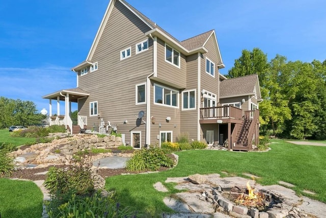 206 Fairway Cir, Glencoe, MN 55336 - back of house with stairs, a fire pit, a yard, and a wooden deck