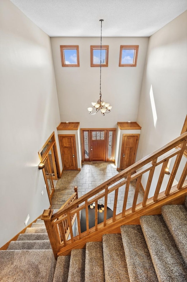 206 Fairway Cir, Glencoe, MN 55336 - stairway featuring a towering ceiling and a chandelier