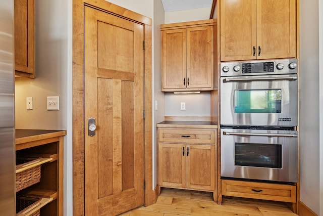 206 Fairway Cir, Glencoe, MN 55336 - kitchen with double oven, light wood finished floors, and light countertops