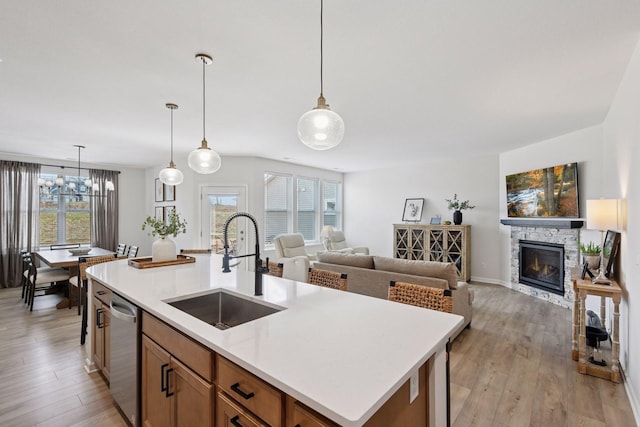 10054 Mulberry Ln, Corcoran, MN 55374 - kitchen featuring a fireplace, open floor plan, a sink, and dishwasher