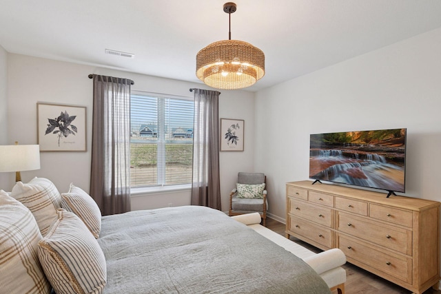 10054 Mulberry Ln, Corcoran, MN 55374 - bedroom featuring a chandelier, visible vents, and wood finished floors