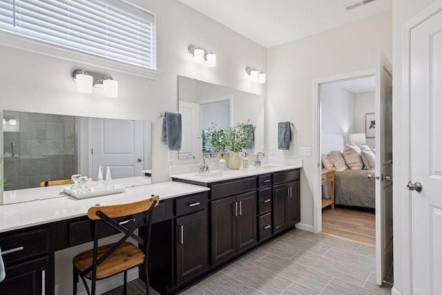 10054 Mulberry Ln, Corcoran, MN 55374 - ensuite bathroom with a stall shower, ensuite bath, double vanity, and a sink