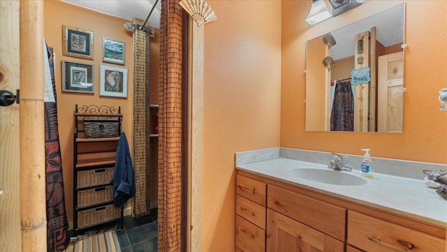 bathroom with vanity, curtained shower, and tile patterned flooring