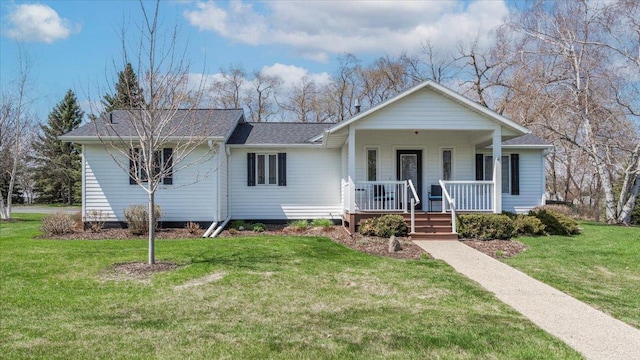 view of front of house with a shingled roof, a porch, and a front yard