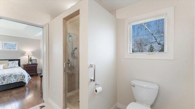 ensuite bathroom with ensuite bathroom, baseboards, toilet, and a shower stall