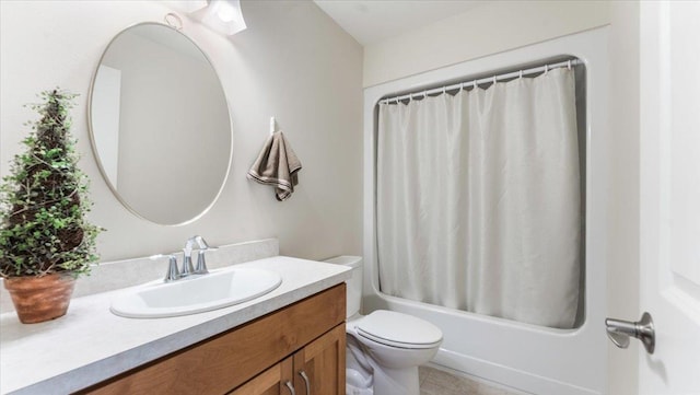 bathroom with vanity, shower / tub combo, and toilet