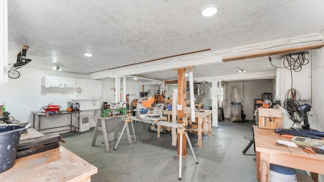 below grade area featuring a workshop area and a textured ceiling