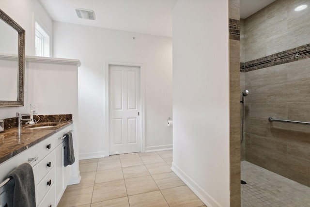 1360 Skyline Dr, Golden Valley, MN 55422 - bathroom with vanity, visible vents, tile patterned floors, a walk in shower, and baseboards