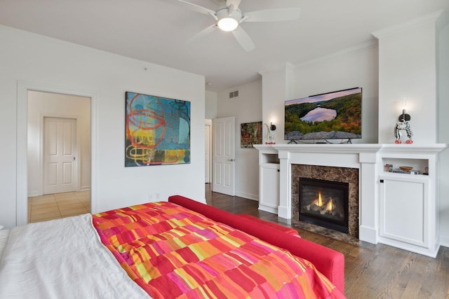 1360 Skyline Dr, Golden Valley, MN 55422 - bedroom with wood finished floors, crown molding, visible vents, ceiling fan, and a high end fireplace
