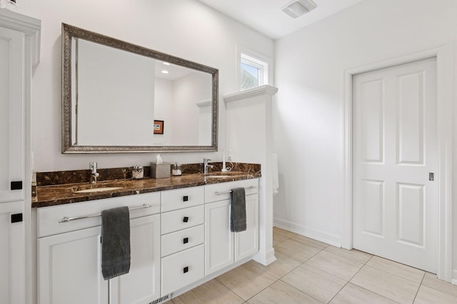 1360 Skyline Dr, Golden Valley, MN 55422 - full bathroom with baseboards, tile patterned flooring, double vanity, and a sink