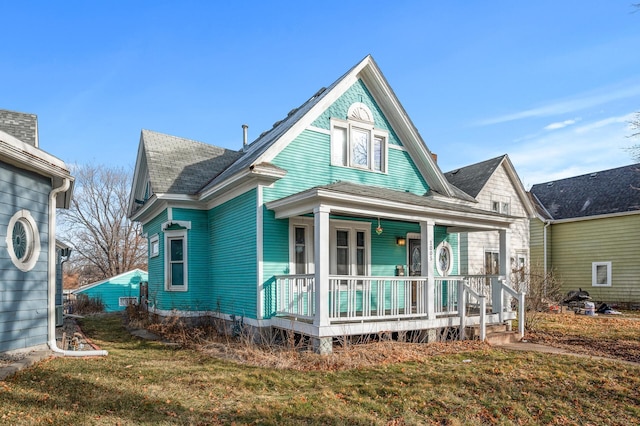 1005 Mclean Ave, Saint Paul, MN 55106 - view of front of home with covered porch and a front lawn