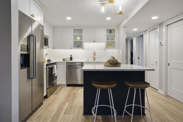 4075 51st St Unit 302, Edina, MN 55424 - kitchen with appliances with stainless steel finishes, a sink, light wood-type flooring, a breakfast bar, and recessed lighting