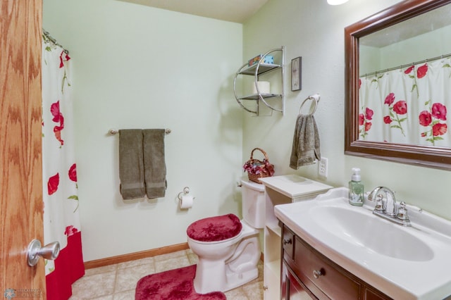 full bath featuring vanity, baseboards, and toilet