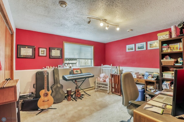 home office featuring a textured ceiling and carpet