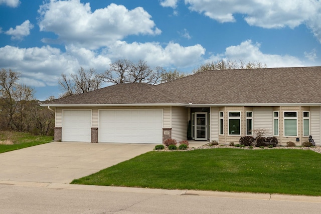 ranch-style home with brick siding, a garage, a front lawn, and concrete driveway