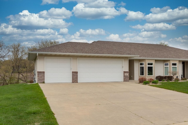 single story home featuring brick siding, an attached garage, a front yard, and concrete driveway