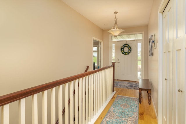 entryway featuring baseboards and light wood finished floors