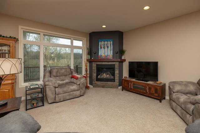 living room with carpet flooring, recessed lighting, baseboards, and a stone fireplace