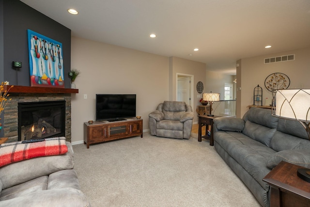 living room featuring visible vents, recessed lighting, carpet flooring, and a stone fireplace