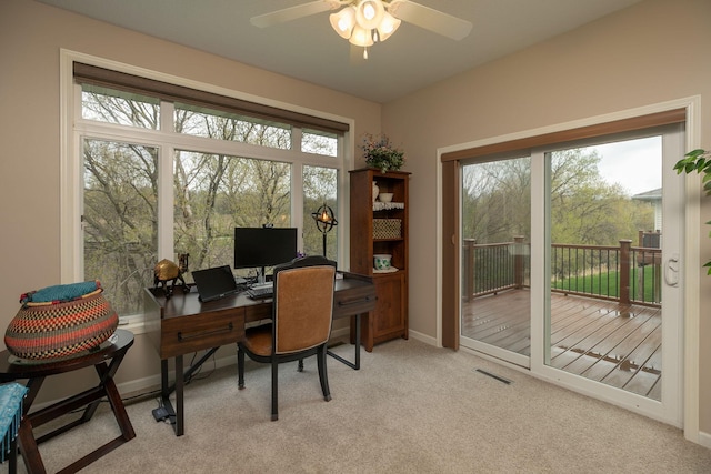 office area with baseboards, a ceiling fan, light colored carpet, and visible vents
