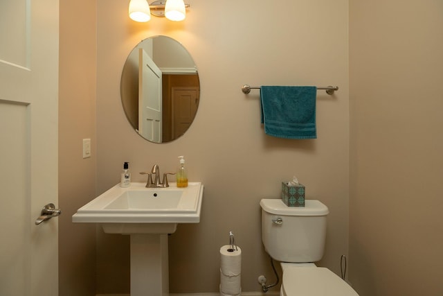 half bathroom featuring toilet