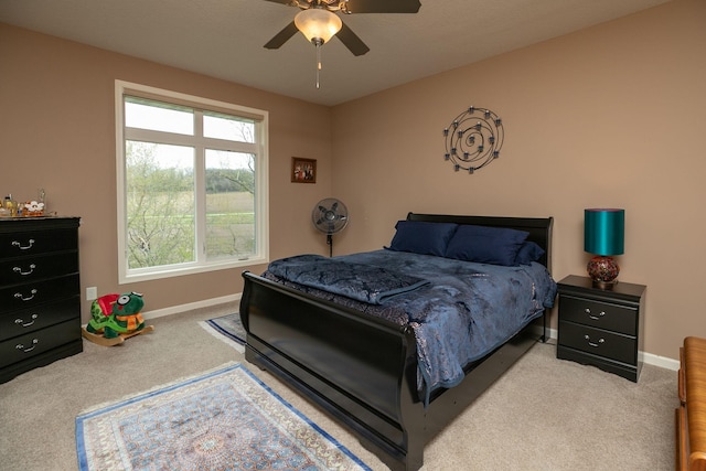 bedroom featuring carpet flooring, a ceiling fan, and baseboards