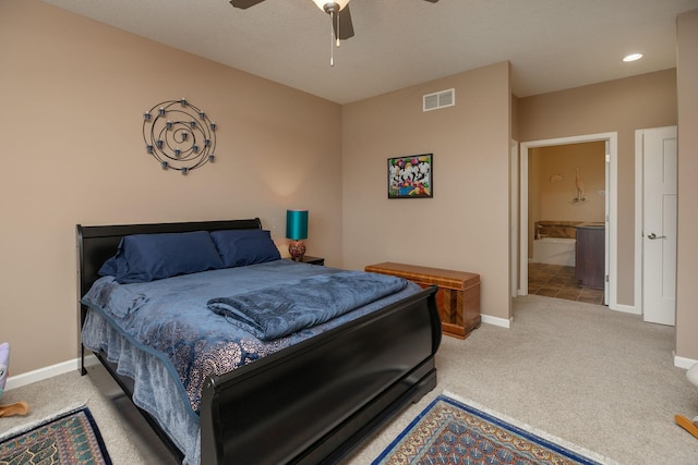 carpeted bedroom featuring ceiling fan, baseboards, visible vents, and ensuite bathroom