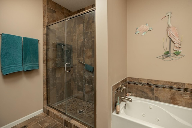 bathroom with a jetted tub, baseboards, and a shower stall