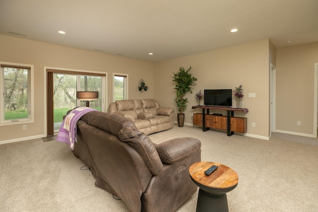 living area with recessed lighting, baseboards, and light colored carpet