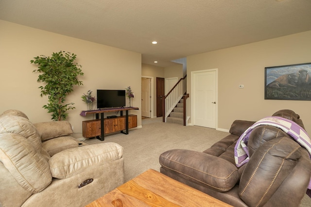 carpeted living room with recessed lighting, baseboards, and stairway